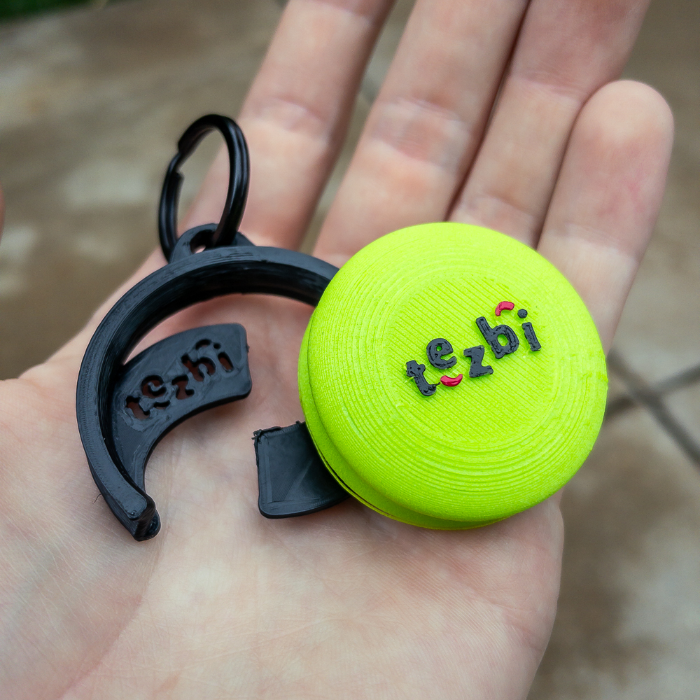 Hand holding neon green Tezbi and holder